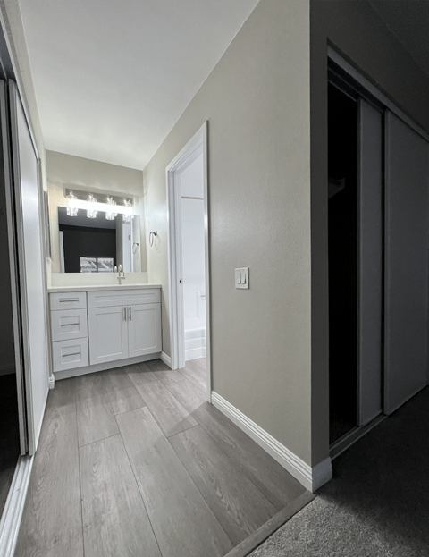 A bathroom with a vanity and a mirror.